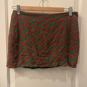 Green with red flowers mini skirt with zipper and slit in the front